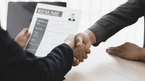 A man getting hired after checking the job market forecast for 2025