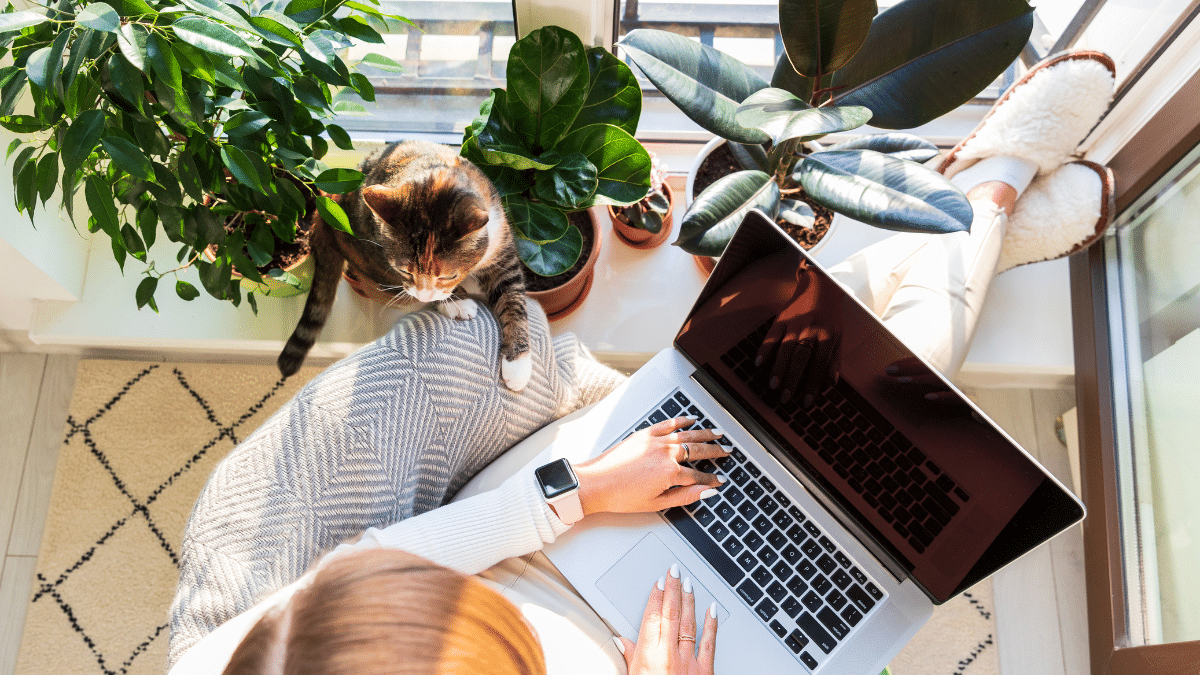 A freelance worker working at home with her cat