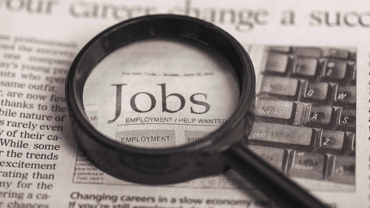 A magnifying glass focused on the word "job"